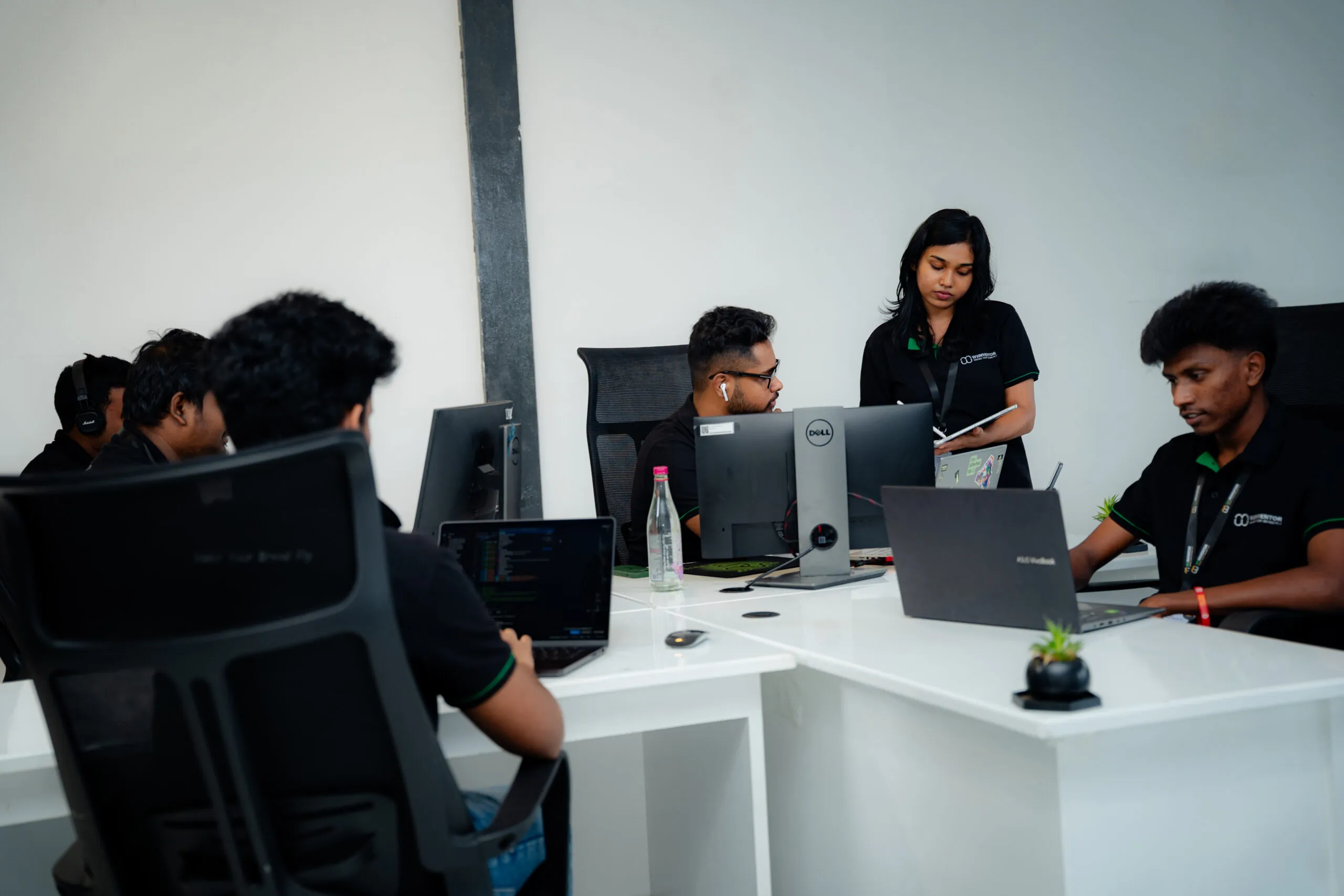 Two W3Inventor colleagues at their desks in the office